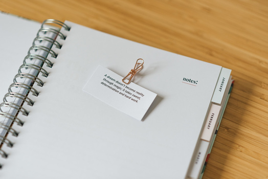 A notebook with an inspirational quote.